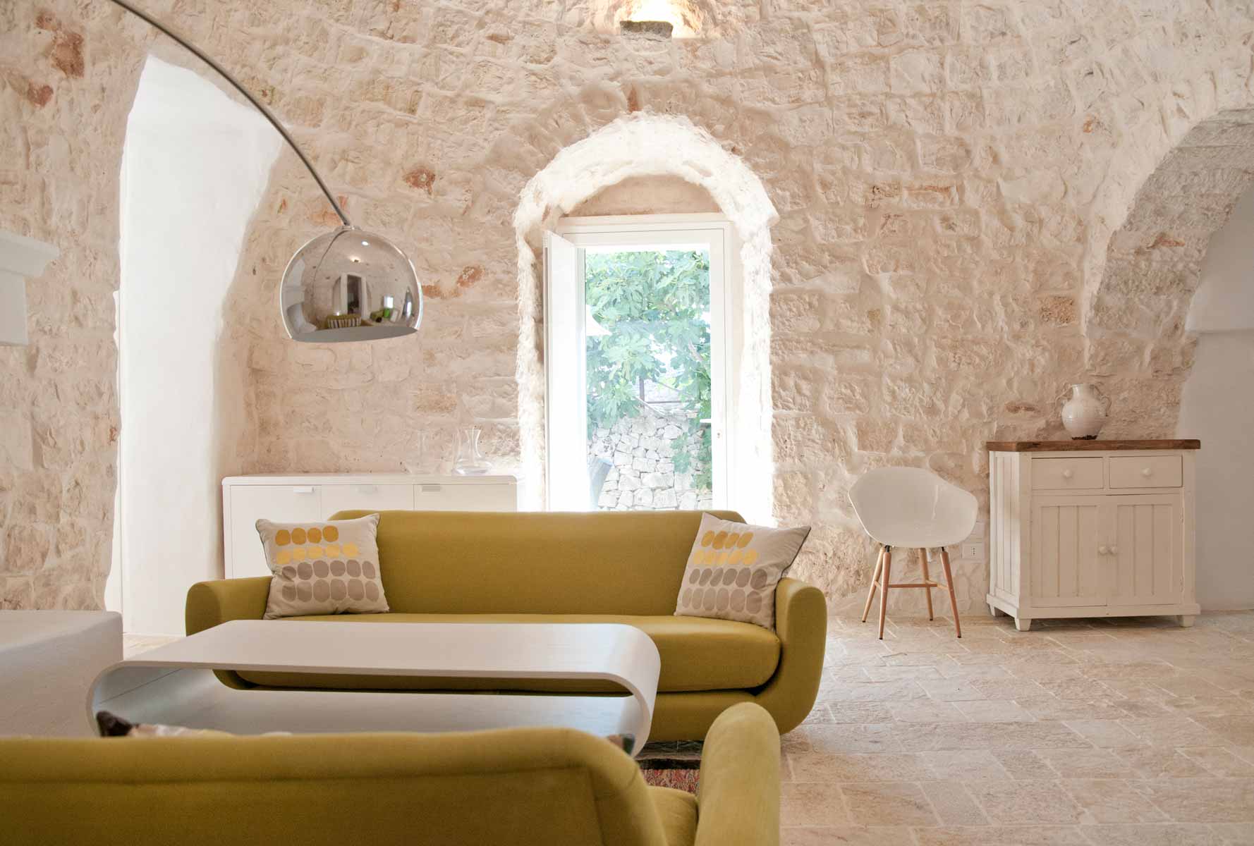 Living room in a restored trullo with swimming pool